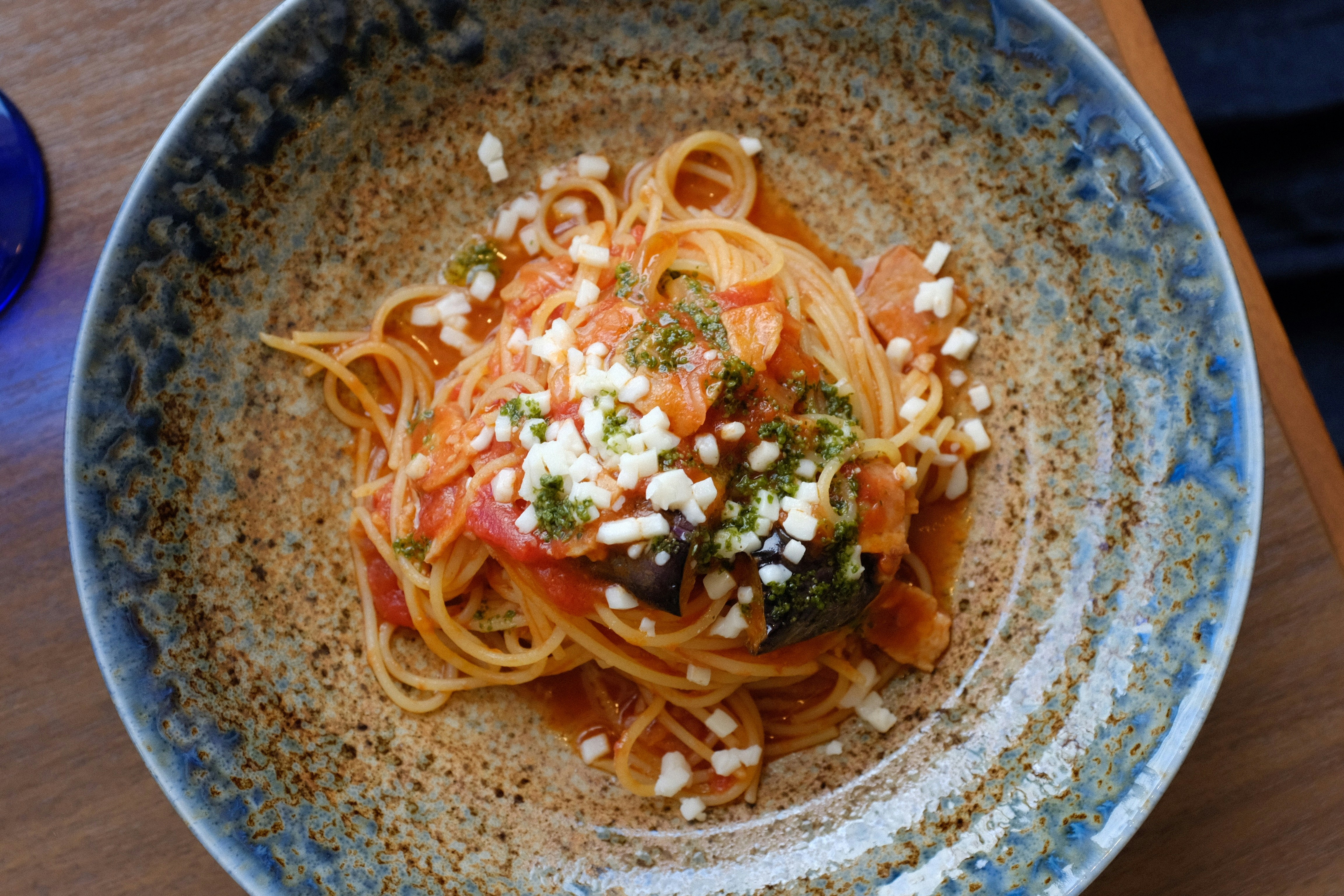 noodles in brown and blue ceramic bowl